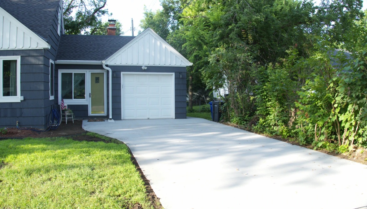 Curved concrete driveway installed by Cornerstone Concrete at a St. Louis Park property