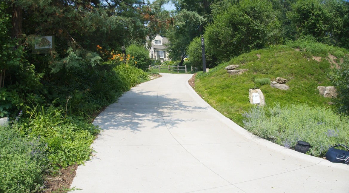 Concrete driveway and walkway installed on a wooded Bloomington, MN property